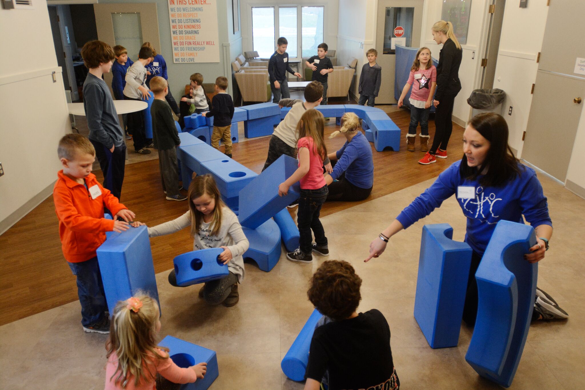 kids and adults playing with blue blocks
