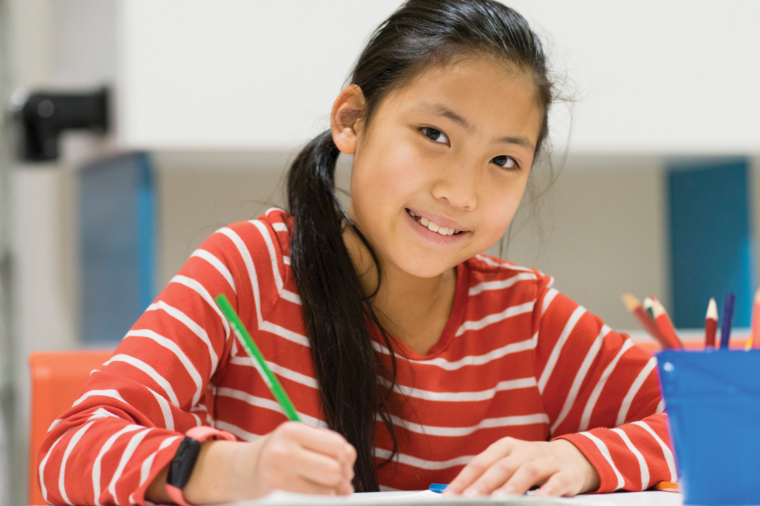 smiling asian girl coloring
